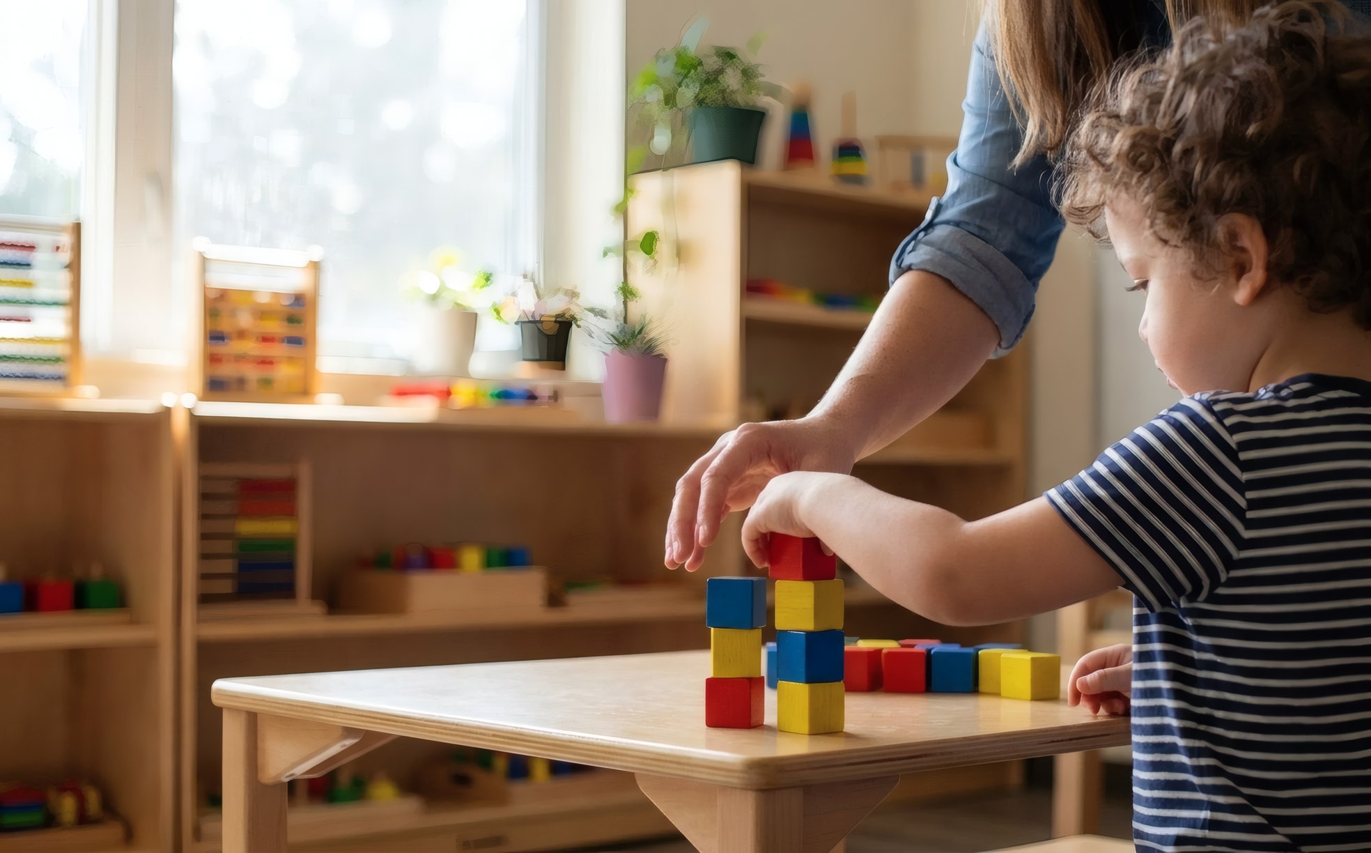 An occupational therapist guiding a child through a fine-motor exercise with coloured blocks